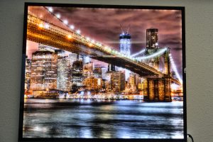 Canvas backlit print of bridge and city lit up.