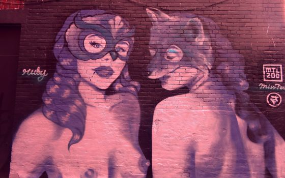 Urban Graffiti-Topless Women with Masks Graffiti art of two topless women wearing masks.