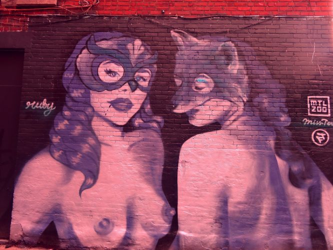 Urban Graffiti-Topless Women with Masks Graffiti art of two topless women wearing masks.