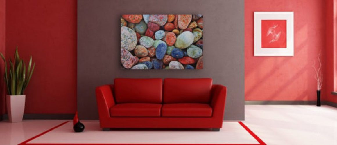 Multi colored rocks on a white washed metal background with gloss.