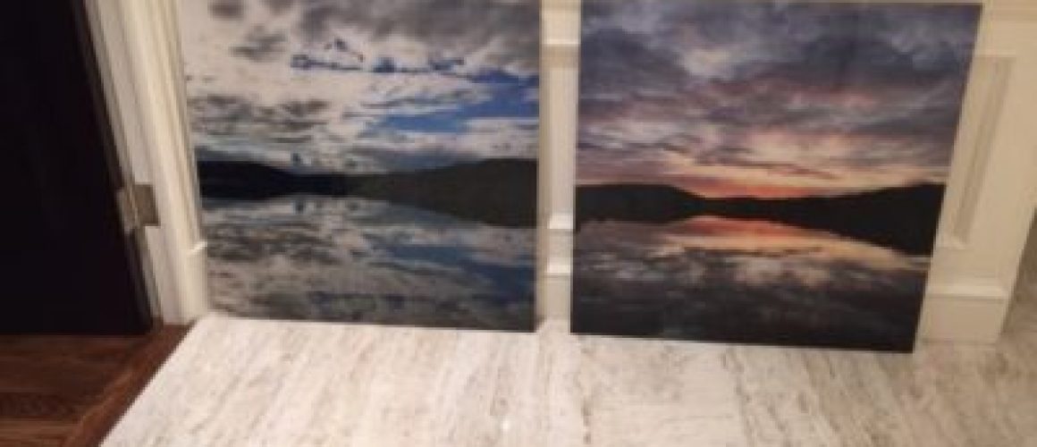 Acrylic print of clouds over mountains and water seperated into two panels.