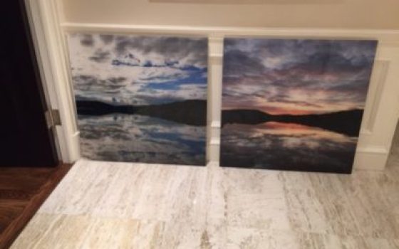 Acrylic print of clouds over mountains and water seperated into two panels.