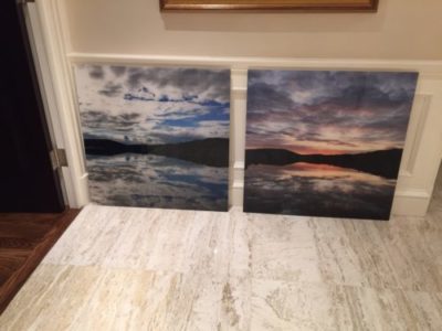 Acrylic print of clouds over mountains and water seperated into two panels.