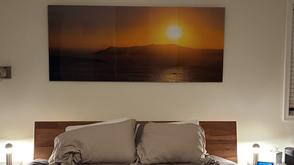above the bed art of a sunset